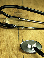 Image showing Medical stethoscope on a wooden desk.