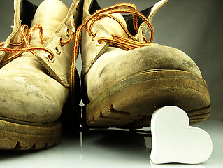 Image showing Heavy military boots trampling heart.