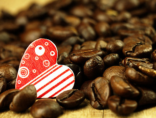 Image showing Heart and Coffee beans close-up on wooden, oak table.