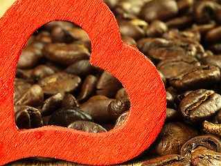 Image showing Heart and Coffee beans close-up on wooden, oak table.