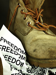 Image showing The word freedom crushed by a heavy, old military boot.