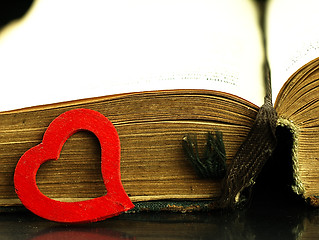 Image showing Heart and old, open book with a damaged cover.