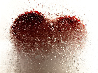 Image showing Red heart embedded in ice.