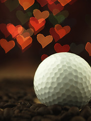 Image showing Golf Ball and coffee beans on the table.