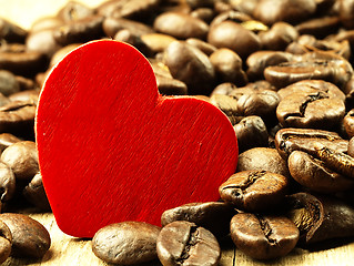 Image showing Heart and Coffee beans close-up on wooden, oak table.