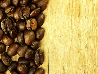 Image showing Coffee beans close-up on wooden, oak table.