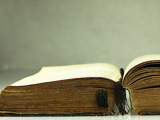 Image showing Old, open book with a damaged cover.