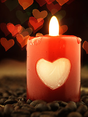 Image showing Red candle and coffee on the table. Shiny hearts in background.