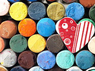 Image showing Heart and colored dry pastels closely.