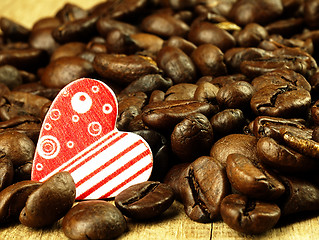 Image showing Heart and Coffee beans close-up on wooden, oak table.