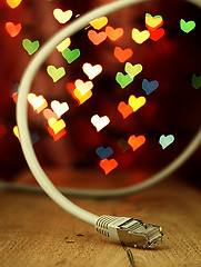 Image showing LAN cable on a background of hearts.