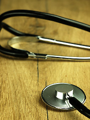 Image showing Medical stethoscope on a wooden desk.