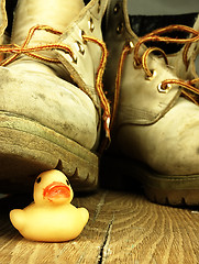 Image showing Rubber duck crushed by a heavy, old military boot.