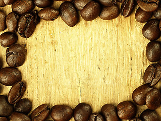 Image showing Coffee beans close-up on wooden, oak table.