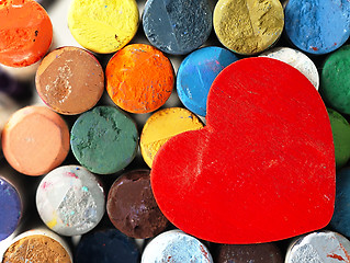 Image showing Heart and colored dry pastels closely.