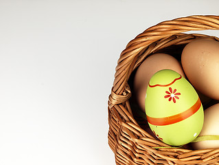 Image showing Colorful Easter egg in the company of ordinary eggs.