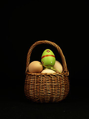 Image showing Colorful Easter egg in the company of ordinary eggs.