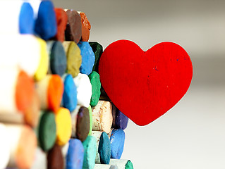 Image showing Heart and colored dry pastels closely.