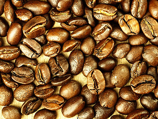 Image showing Coffee beans close-up on wooden, oak table.