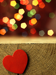 Image showing Red heart on the edge of a wooden table.