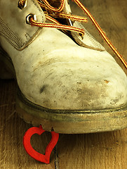 Image showing Rubber duck crushed by a heavy, old military boot.