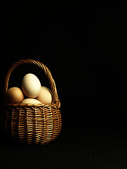 Image showing Easter eggs in a wicker basket.