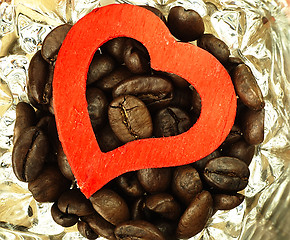 Image showing Heart and Coffee beans close-up on wooden, oak table.