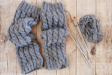 Image showing wool grey legwarmers, knitting needles and yarn