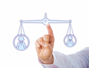 Image showing Balancing A Big Versus A Small Female Worker