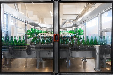 Image showing Bottling machine with many bottles