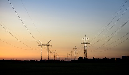 Image showing Large transmission towers at sunset