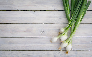 Image showing Scallions on a wooden table