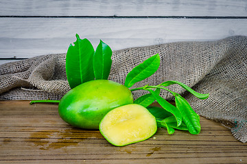 Image showing Mango on a wooden table