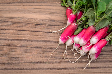 Image showing Radishes on a wooden table