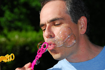 Image showing Man blowing bubbles