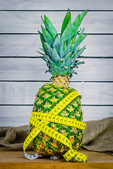 Image showing Pineapple with measure tape on a table