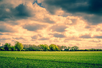 Image showing Dark clouds over a field