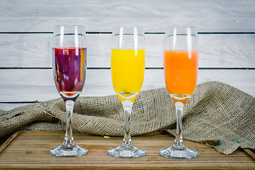 Image showing Juice variations on a wooden table