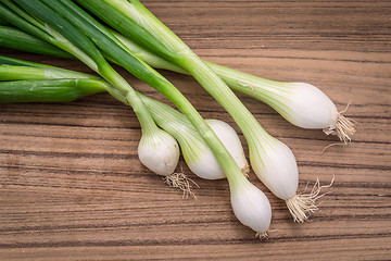 Image showing Scallions on a wooden board