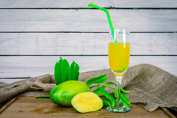 Image showing Mango juice on a wooden table