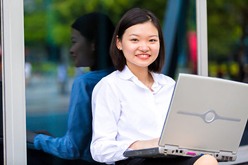 Image showing Young Asian female executive using laptop PC