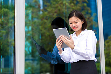 Image showing Young Asian female executive using tablet PC