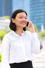 Image showing Young Asian female executive using smart phone