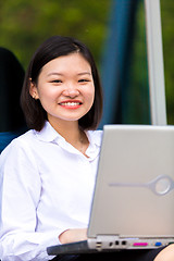 Image showing Young Asian female executive using laptop PC