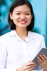 Image showing Young Asian female executive using tablet PC