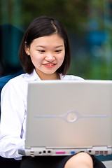 Image showing Young Asian female executive using laptop PC