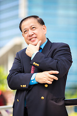 Image showing Senior Asian businessman in suit smiling portrait