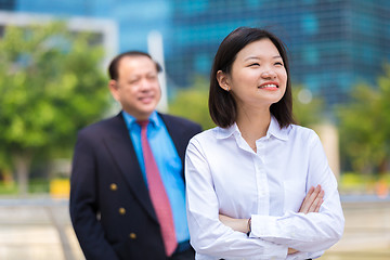 Image showing Young Asian female executive and senior businessman in suit portrait