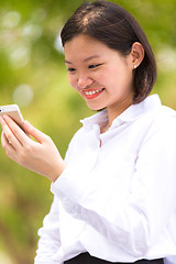 Image showing Young Asian female executive using smart phone