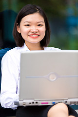 Image showing Young Asian female executive using laptop PC